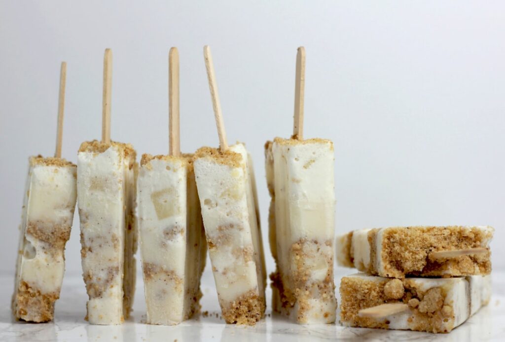 Cozy inviting image of spiced cinnamon churro pudding pops light brown perhaps dusted with a hint of cinnamon on a rusti