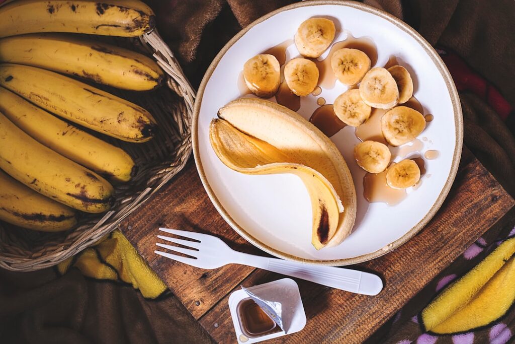 Sliced ripe bananas arranged on a parchment-lined baking sheet ready for flash-freezing before being stored in a freezer