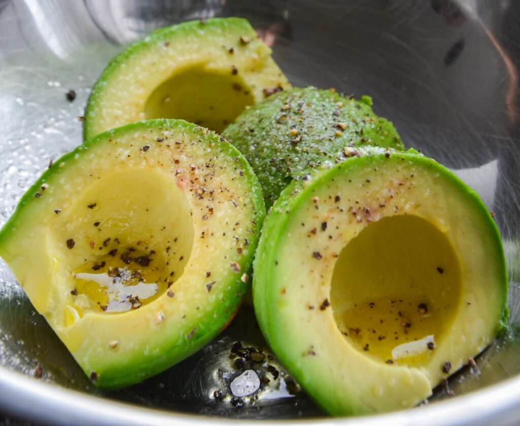 A vibrant fresh salad drizzled generously with green avocado oil