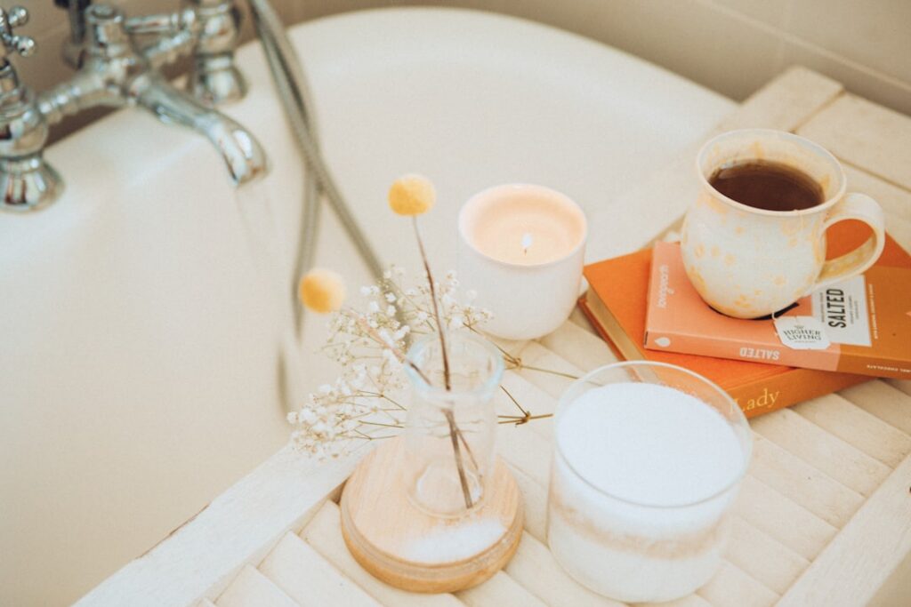 A bathtub filled with milky water and floating oats with a delicate lavender sprig on the edge creating a serene and soo