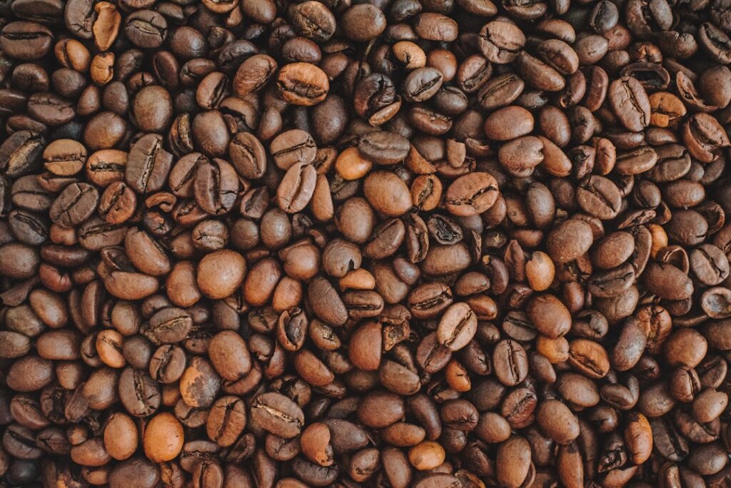 A close-up shot of fresh coffee grounds and a whole egg highlighting the natural ingredients used in the mask