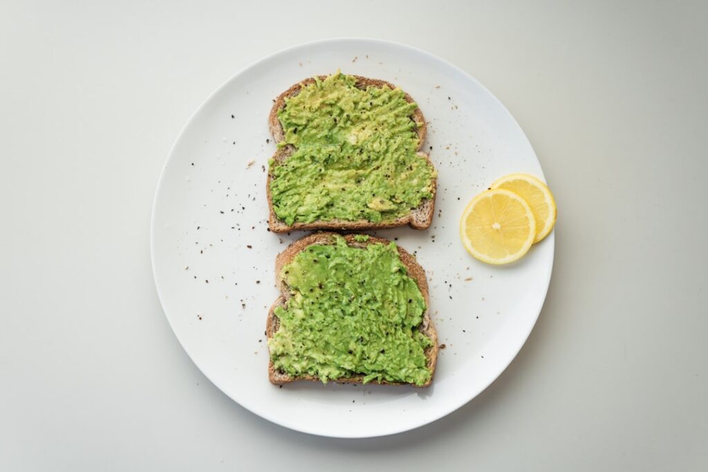 A close-up appealing shot of avocado toast on whole-grain bread generously topped with everything bagel seasoning and a 