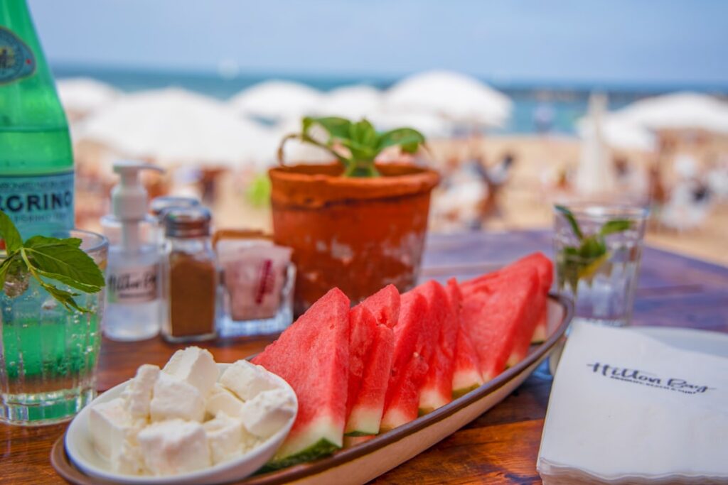 A close-up of colorful watermelon skewers with feta and mint ready to be served on a platter