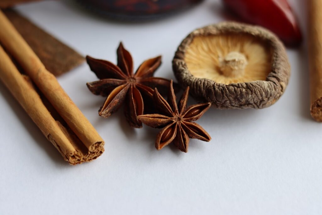 Close-up of cinnamon sticks infusing in a glass of warm water with steam gently rising