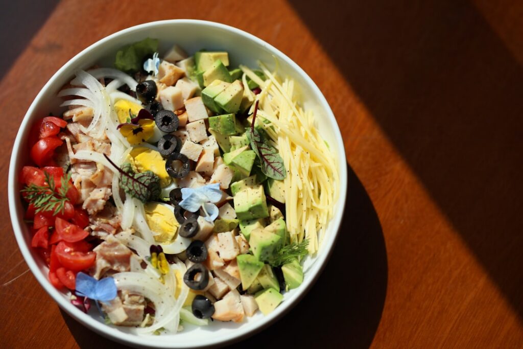A vibrant Pinterest-friendly top-down shot of a savory cottage cheese bowl The bowl contains creamy cottage cheese toppe