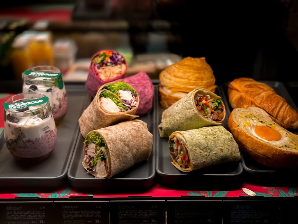 A close-up shot of two different healthy lunch wraps cut in half and stacked revealing their fresh colorful fillings One