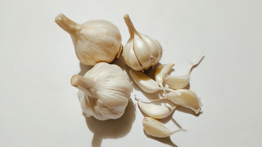 Close-up image of fresh garlic cloves some peeled showing their natural texture and color