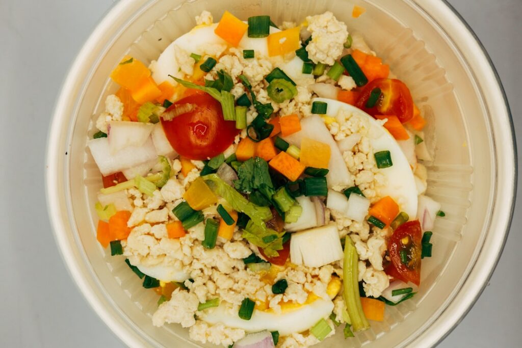 A close-up shot of a savory cottage cheese bowl possibly with tomatoes cucumber and dill emphasizing fresh ingredients a