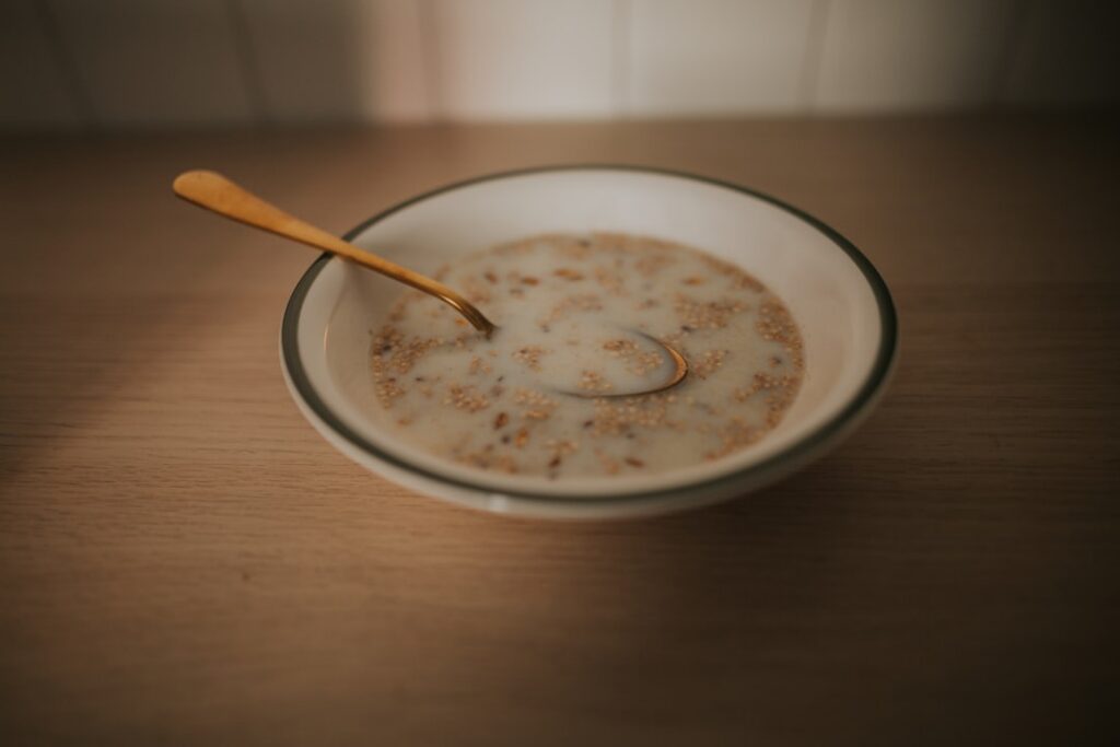 A close-up Pinterest-friendly shot of a creamy bowl of oatmeal with a generous swirl of peanut butter and a sprinkle of 