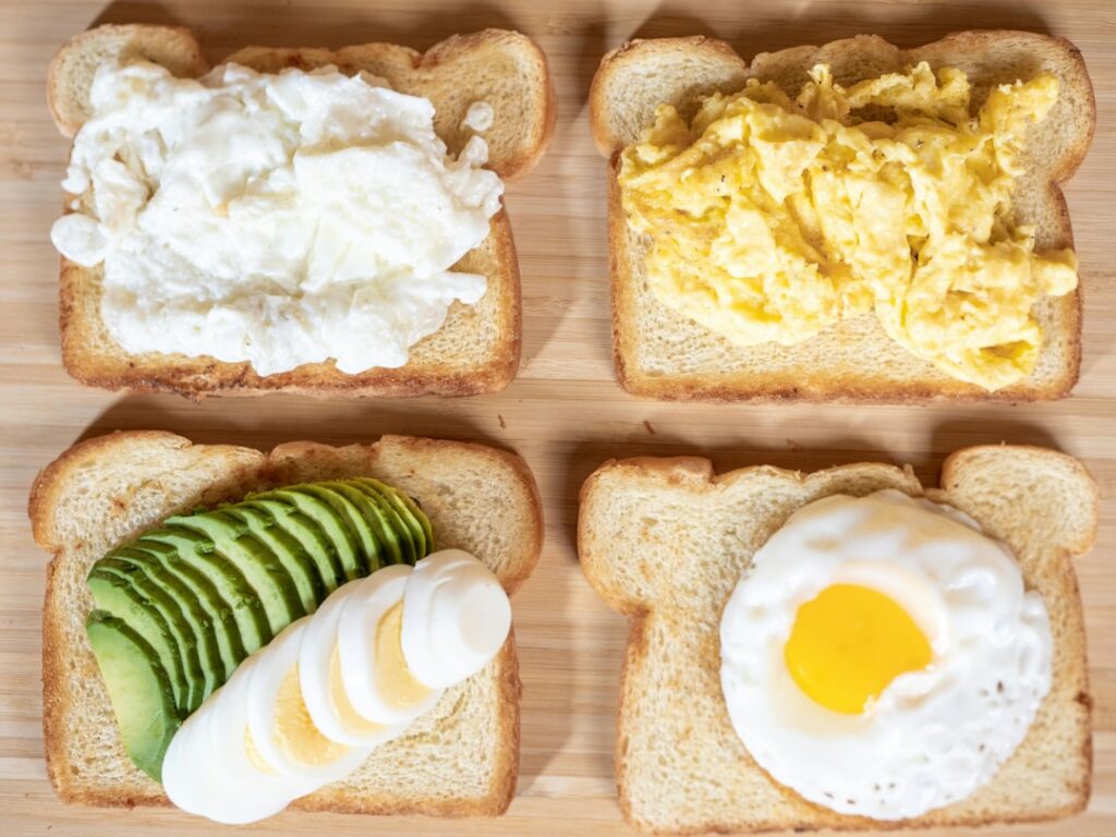 A vibrant and delicious breakfast bowl featuring scrambled eggs topped with fresh avocado slices cherry tomatoes and a s