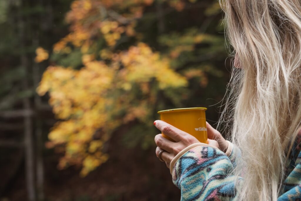 A close-up of a person s hands gently cupping a ceramic mug filled with the steaming golden spiced elixir perhaps with a