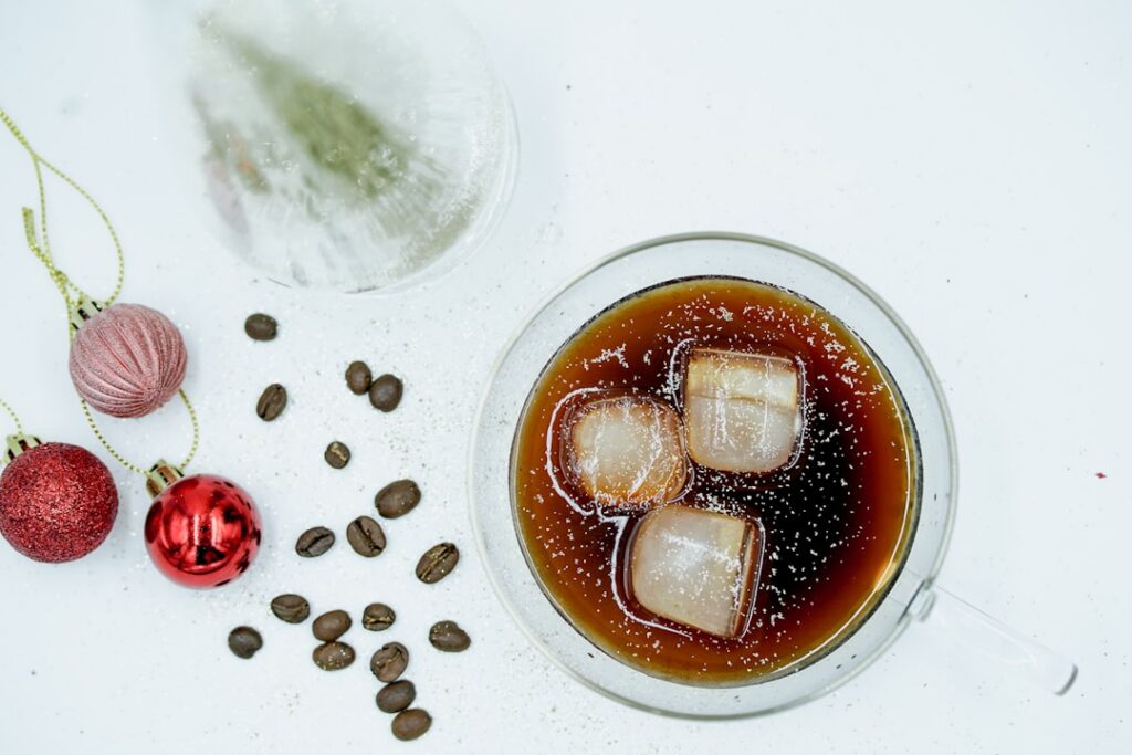 Ingredients for making coffee ice cubes a cup of brewed coffee an empty ice cube tray and optionally coffee beans in the