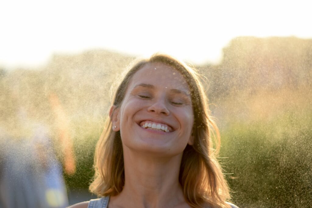A woman with a smooth clear complexion smiling representing radiant and healthy skin achieved through natural care