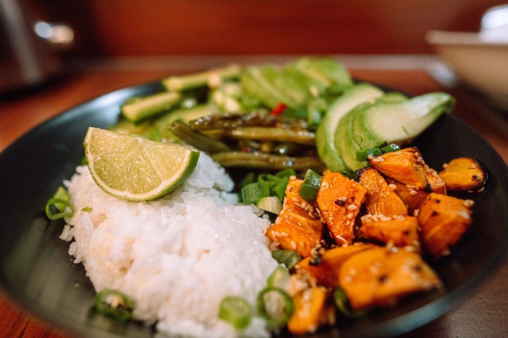 A vibrant balanced meal featuring salmon broccoli and sweet potatoes on a plate representing a brain-healthy dinner