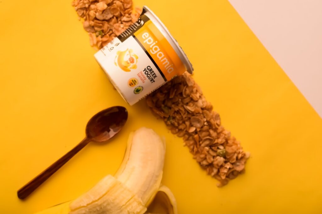 Flat lay of fresh bananas a bowl of honey and a mashed banana mixture in a wooden bowl ready for a DIY hair mask