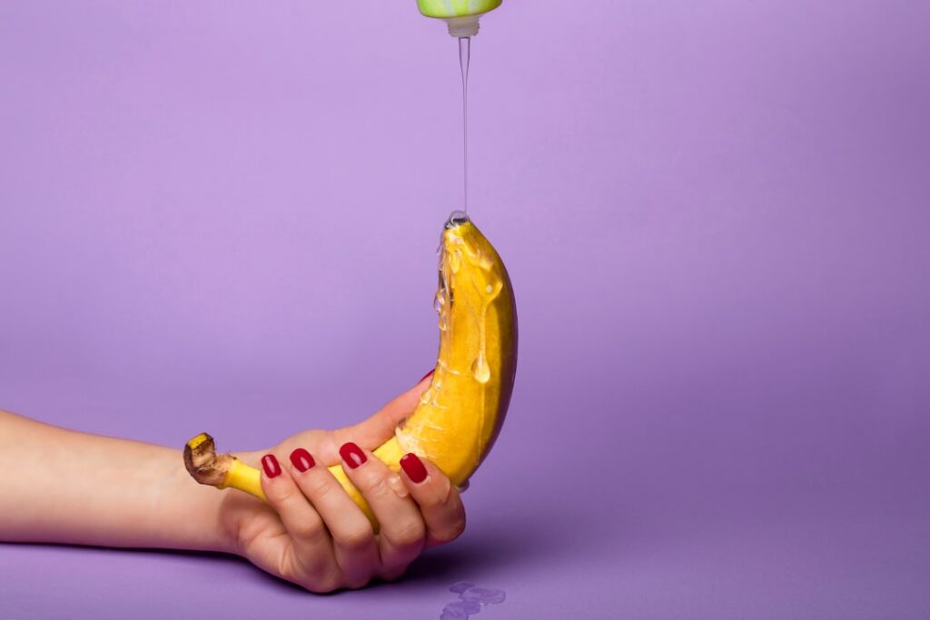 Woman applying a homemade banana hair mask to her hair gently massaging it in