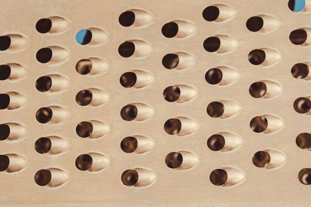 A close-up diagram illustrating how to drill drainage holes in the bottom of a planter with an arrow pointing from the t