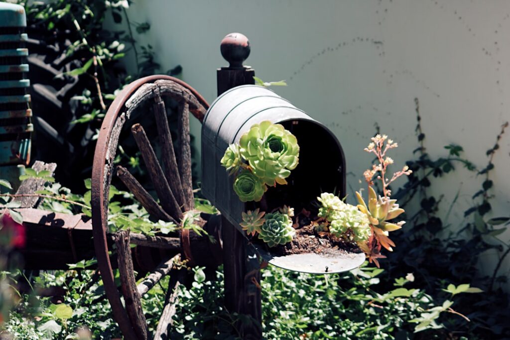 A collage of various creative upcycled garden planters including painted tires a vertical pallet garden an old bathtub f