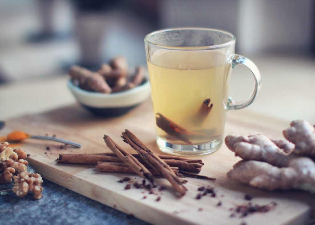 A warm comforting beverage made with natural ingredients like ginger red onion and cinnamon perhaps in a rustic mug with