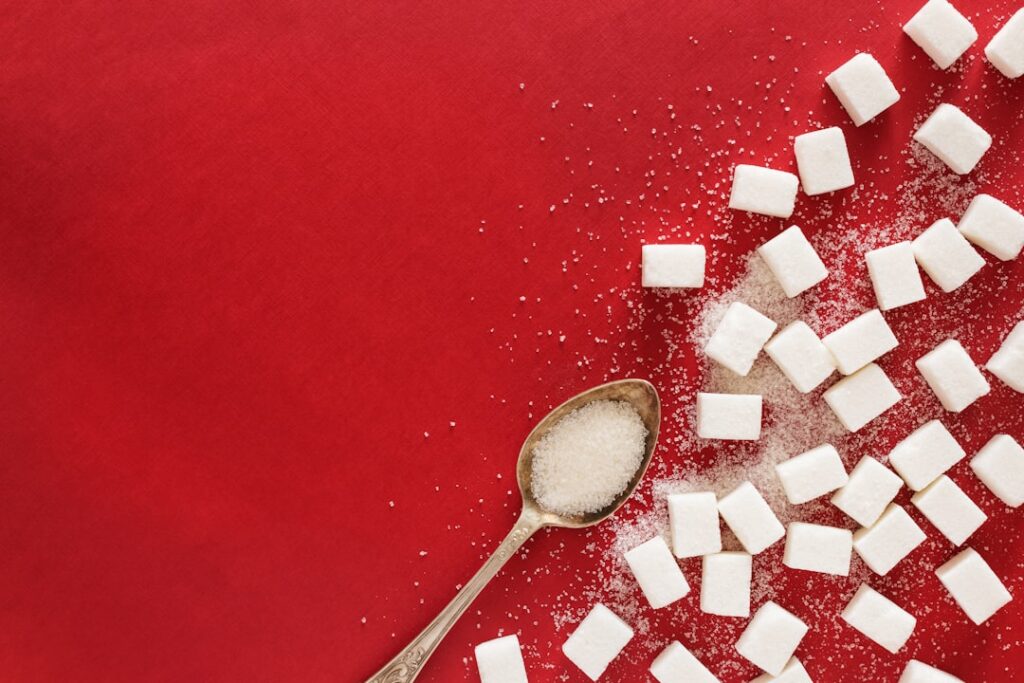 An infographic titled Shocking Sugar Truths Revealed showing various common food items with surprising amounts of hidden