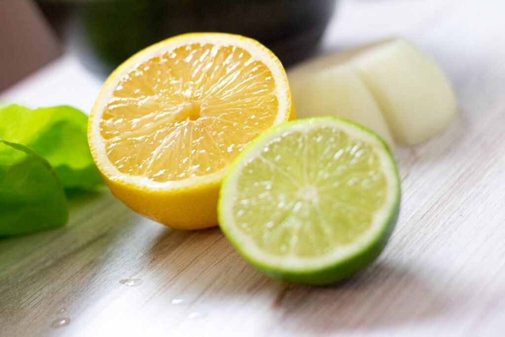 Ingredients for a chia lime dressing including a bowl of chia seeds fresh limes and a bottle of honey or maple syrup