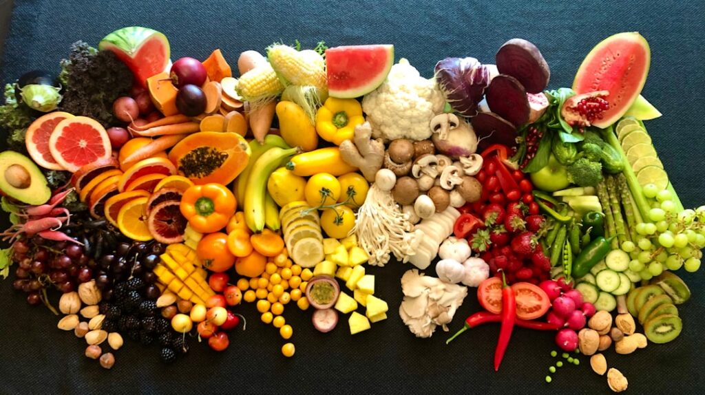 A vibrant overhead shot of a diverse selection of brain-boosting foods artfully arranged on a wooden table including egg