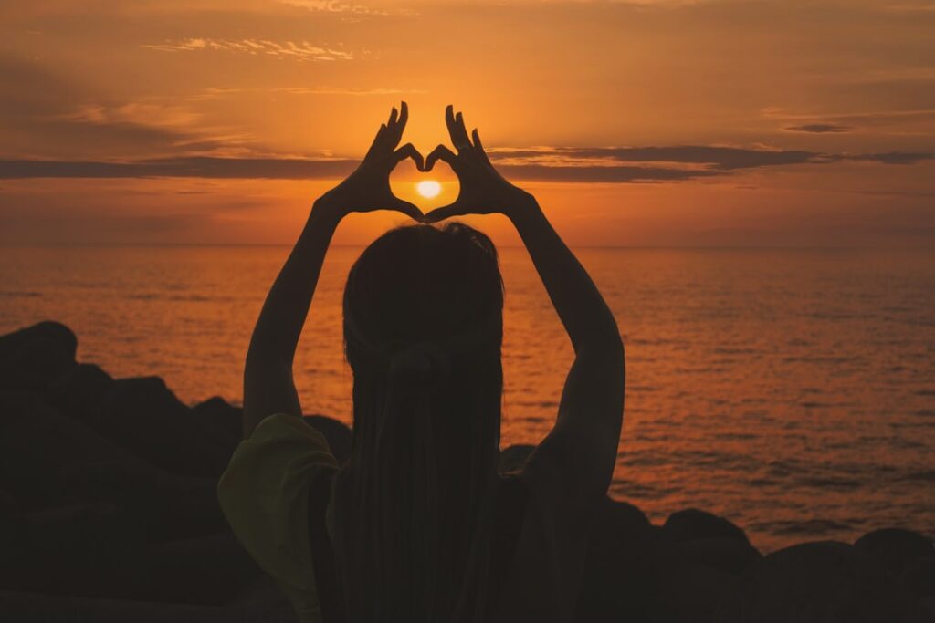 A thoughtful woman in her 30s or 40s considering her health possibly with a subtle hand gesture near her chest or head c