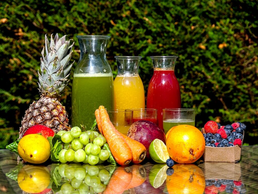 A variety of colorful fresh fruits and vegetables such as oranges pineapples strawberries cucumbers and kale arranged ap