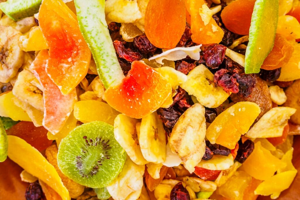 A vibrant bowl filled with a variety of mixed dry fruits including almonds walnuts figs apricots pistachios and cashews