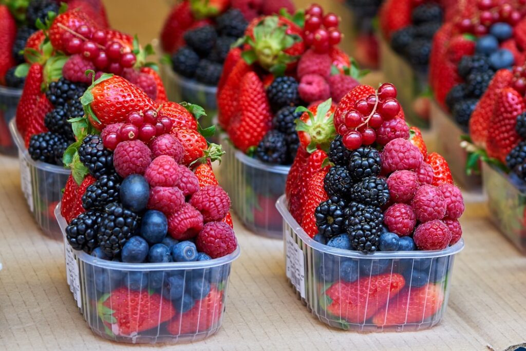 A vibrant bowl of fresh berries possibly with a sprinkle of nuts symbolizing healthy snacking
