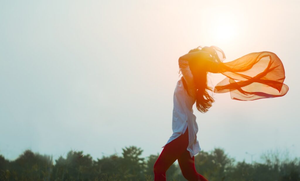 A person looking energetic and happy possibly jogging outdoors or enjoying a healthy meal symbolizing improved energy le
