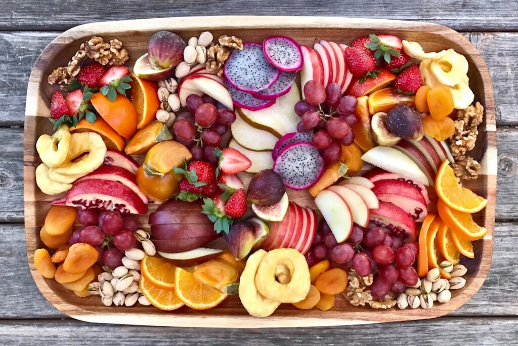 A vibrant colorful assortment of various fresh fruits like berries citrus apples bananas and tropical fruits arranged ae