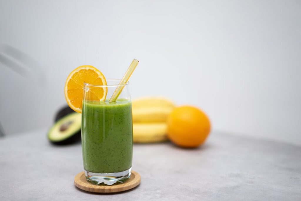 Assortment of vibrant healthy drinks like infused water green tea and a berry smoothie arranged aesthetically