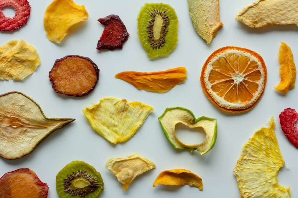 A vibrant assortment of various dry fruits almonds walnuts dates raisins apricots arranged appealingly on a wooden board