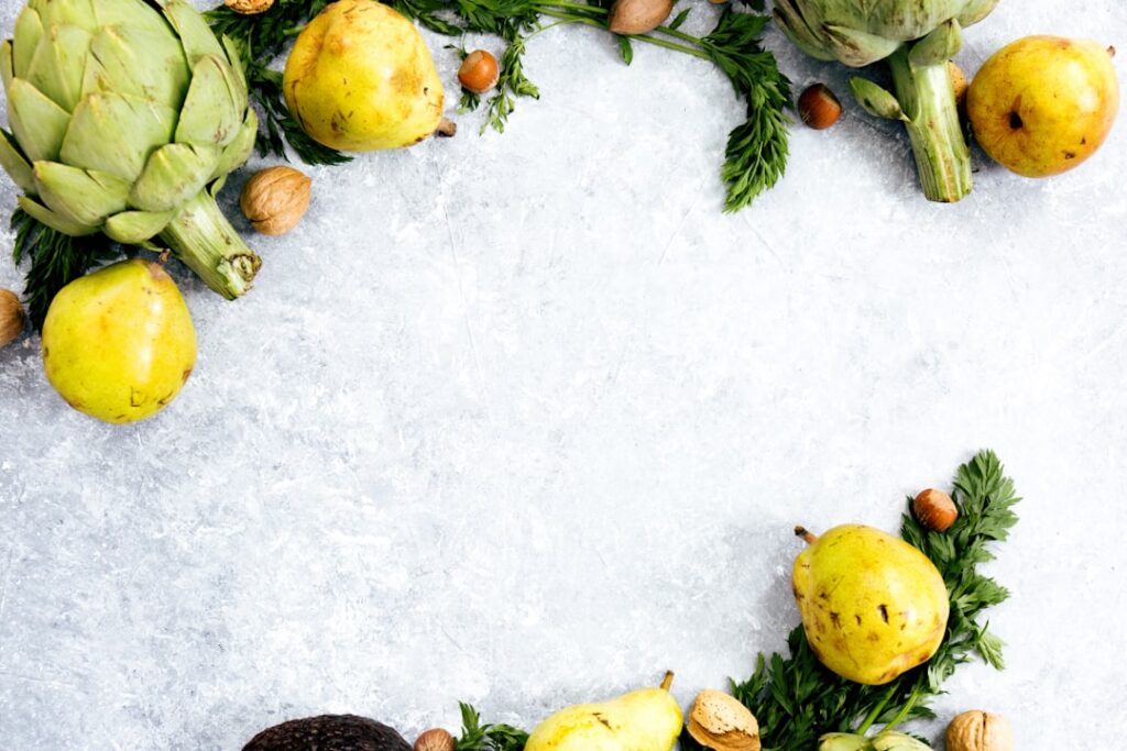 A vibrant aesthetically pleasing flat lay of various liver-healthy foods including turmeric root fresh leafy greens like