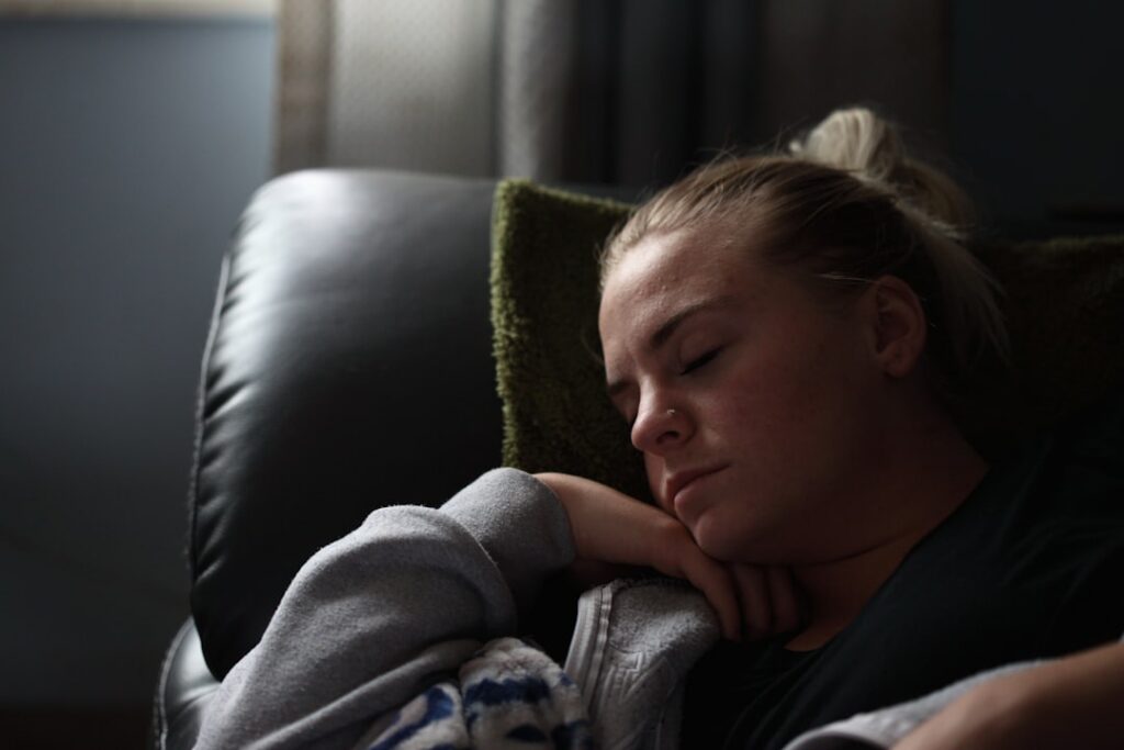A person looking tired or experiencing a slight brain fog surrounded by soft warm light to symbolize subtle symptoms of 
