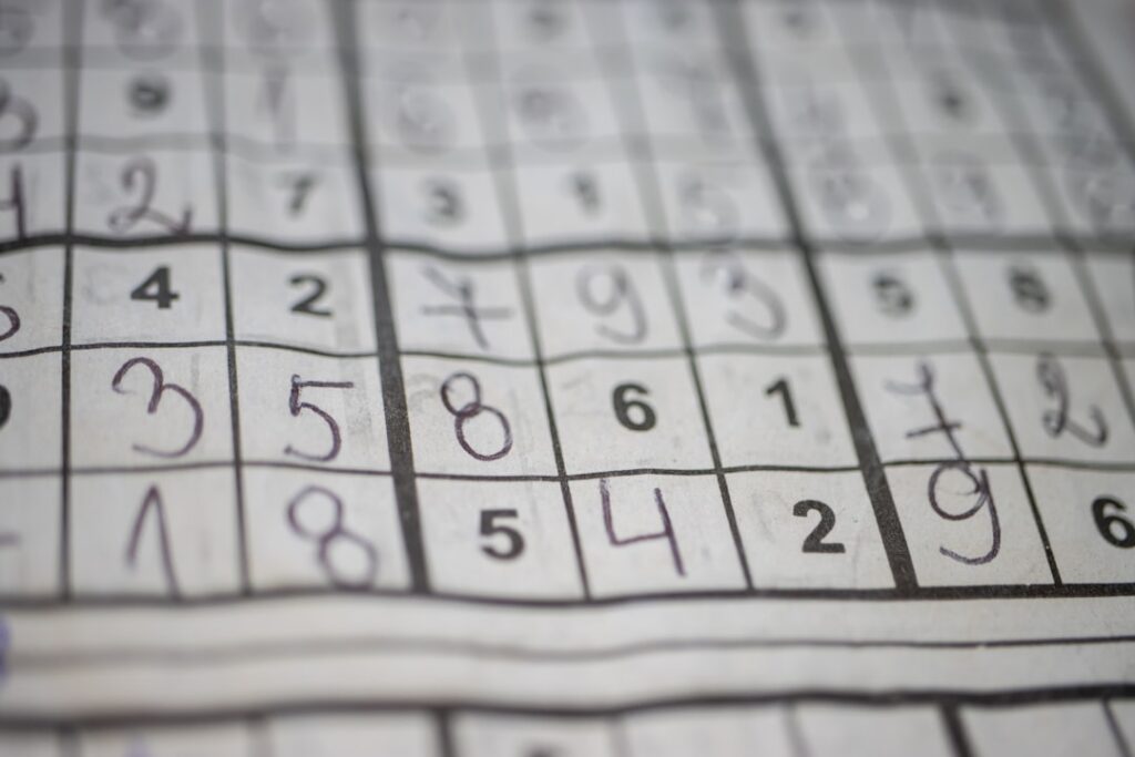 A complex logic puzzle grid or a visual representation of the Einstein s puzzle with numbers symbols and a question mark