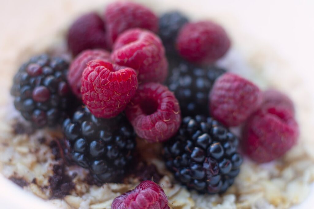 A close-up image of a vibrant bowl of oatmeal topped with fresh berries and nuts emphasizing a healthy and appealing bre