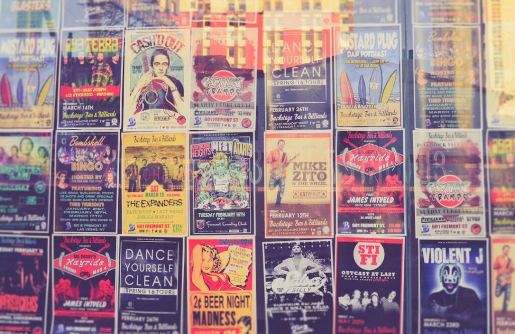 A vintage concert poster featuring a classic rock and roll musician performing on stage with energetic crowd silhouettes