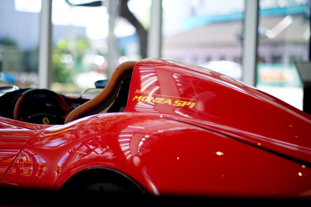 An image of Tom Selleck as Magnum P I with his iconic red Ferrari in Hawaii set against a vibrant 80s backdrop evoking n