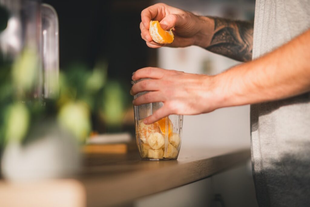 A close-up of a person blending ingredients in a high-speed blender creating a creamy frappuccino The focus is on the ac
