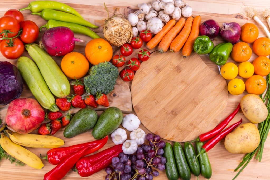 A vibrant colorful spread of various water-rich fruits and vegetables like watermelon cucumber strawberries and oranges 