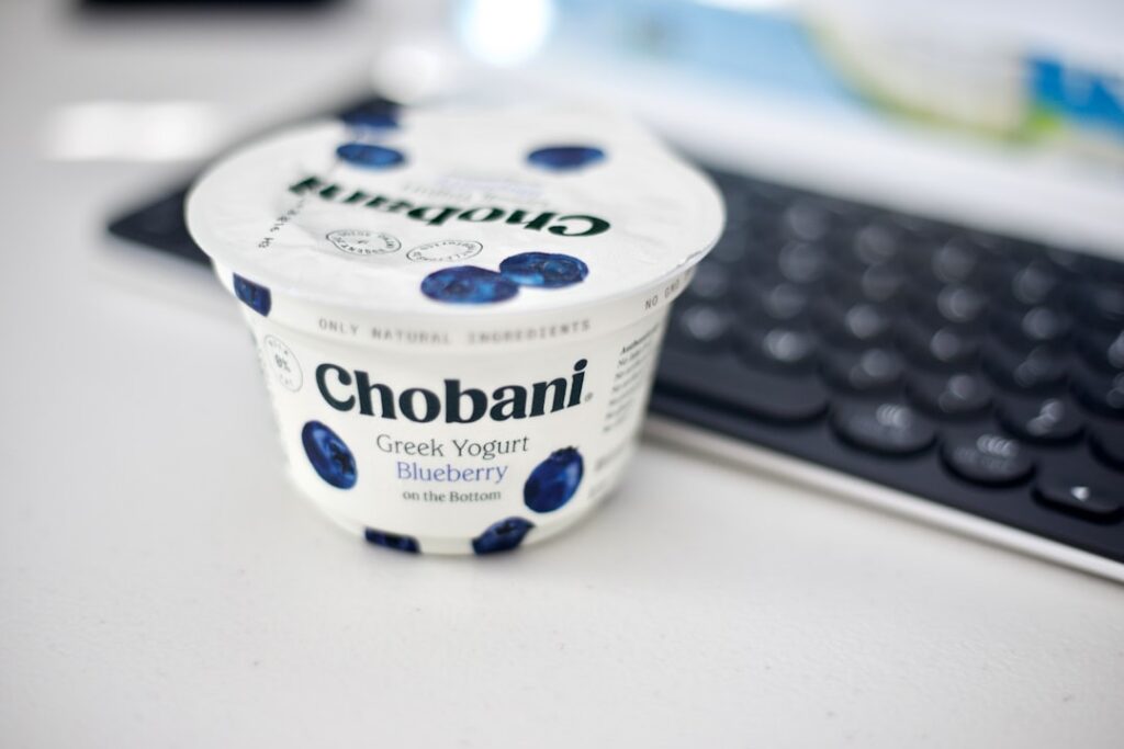 A bowl of plain Greek yogurt with a side of cottage cheese depicting portions that could combine to offer 30g of protein