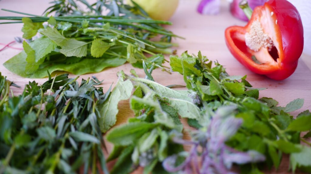 A vibrant assortment of kidney-friendly foods such as berries cranberries leafy greens like spinach and kale apples and 