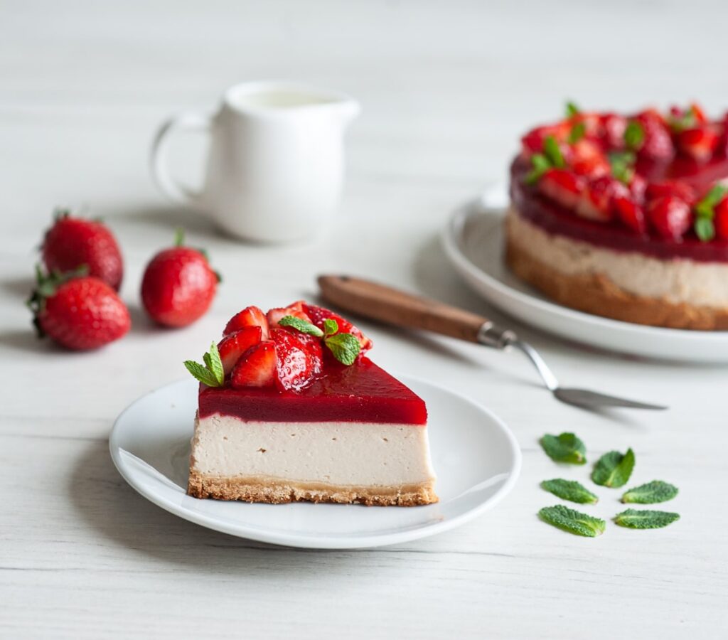 A beautiful overhead shot of a finished No-Bake Strawberry Cheesecake Lasagna showing distinct layers of crunchy crust c