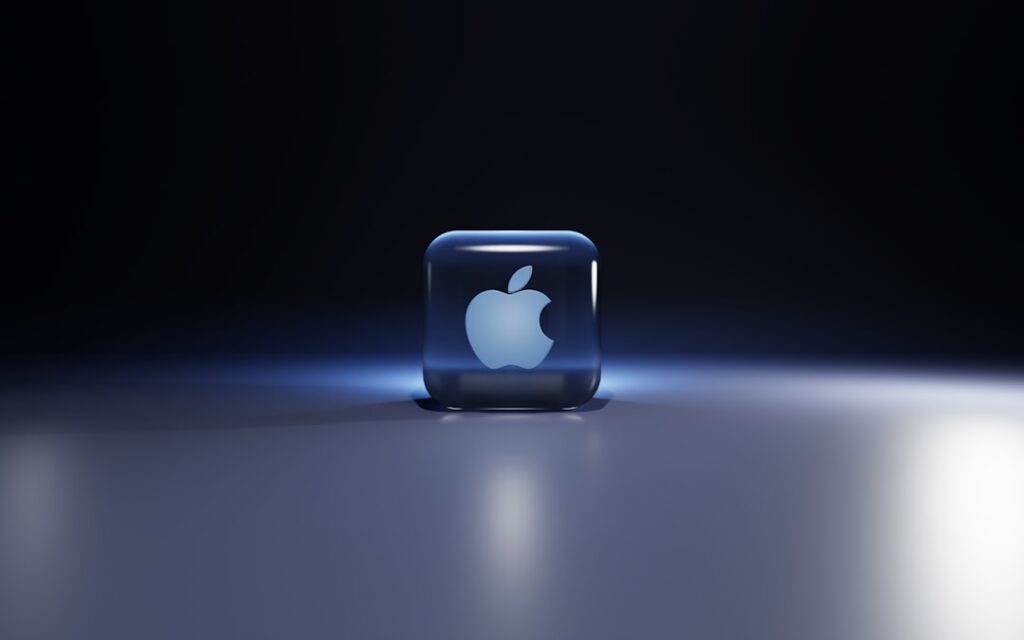 A split image showing the Apple Inc logo on one side and a fresh crisp red apple fruit on the other symbolizing the conn