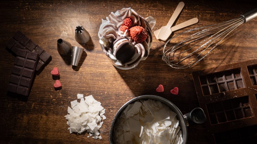 Various ingredients for homemade ice candy such as fresh fruits mango strawberries milk cocoa powder and ice candy pouch