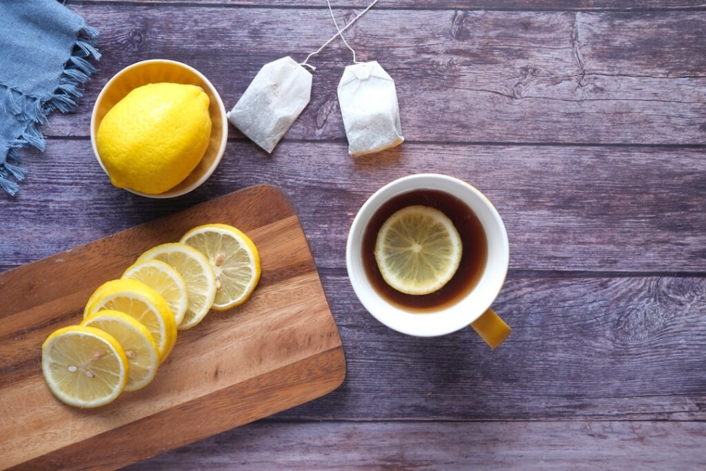 A warm cup of Mullein tea with honey and a lemon slice steeping in a clear mug