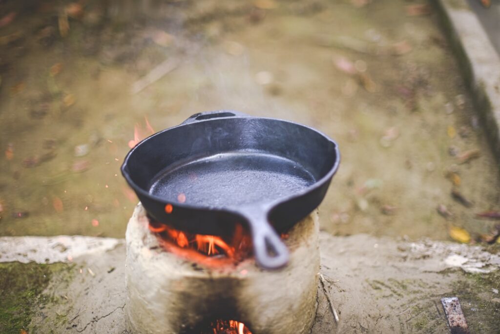 Golden-brown fried chicken pieces sizzling in hot oil in a cast iron skillet