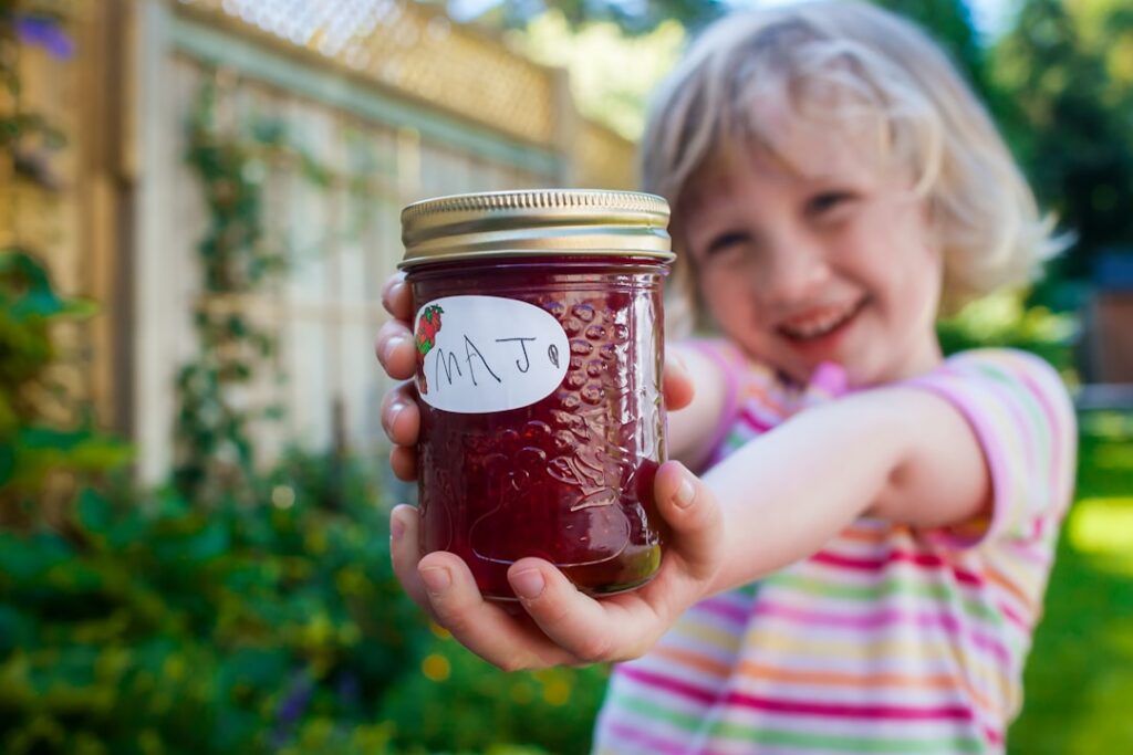 A visual representation of a jar of jam next to a stack of money forming a rebus puzzle